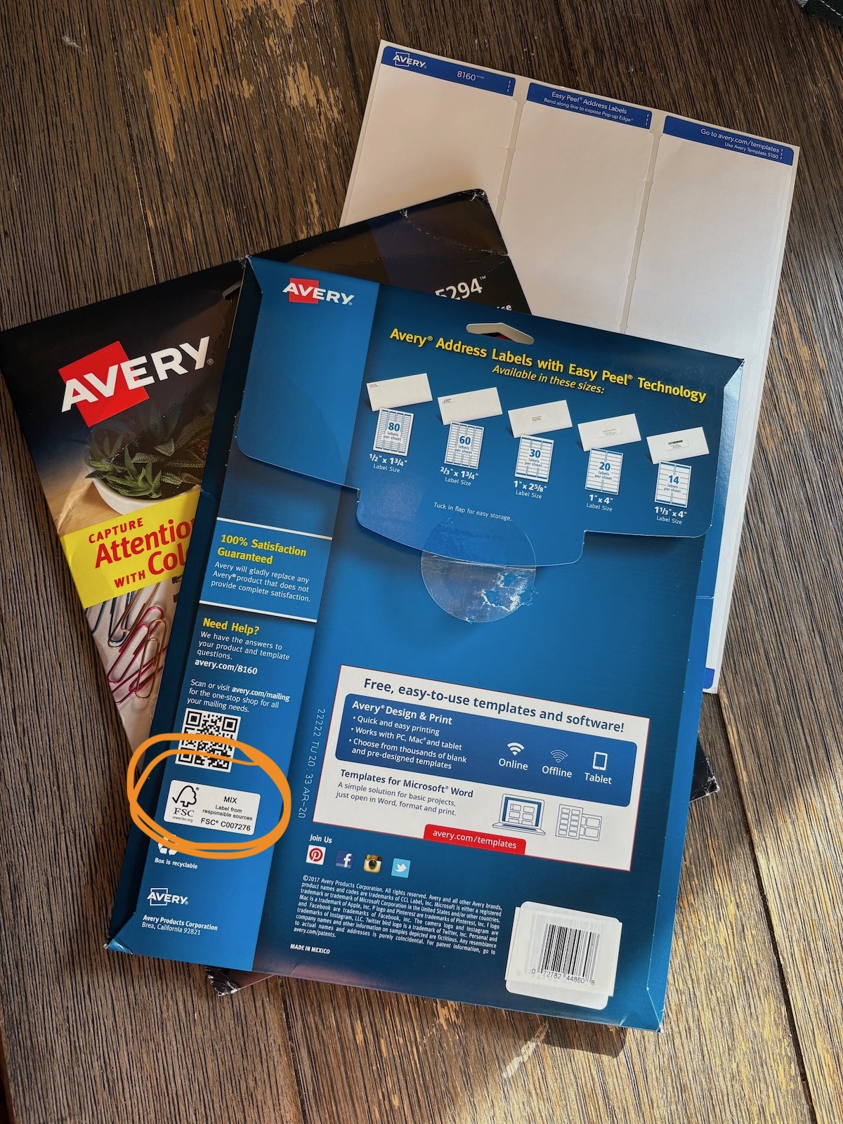 avery A package of Avery labels sitting on a wooden desk