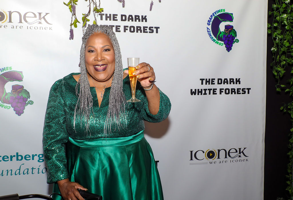 melody-4 Melody Mobley raises a glass of champagne to toast the premiere of The Dark White Forest.