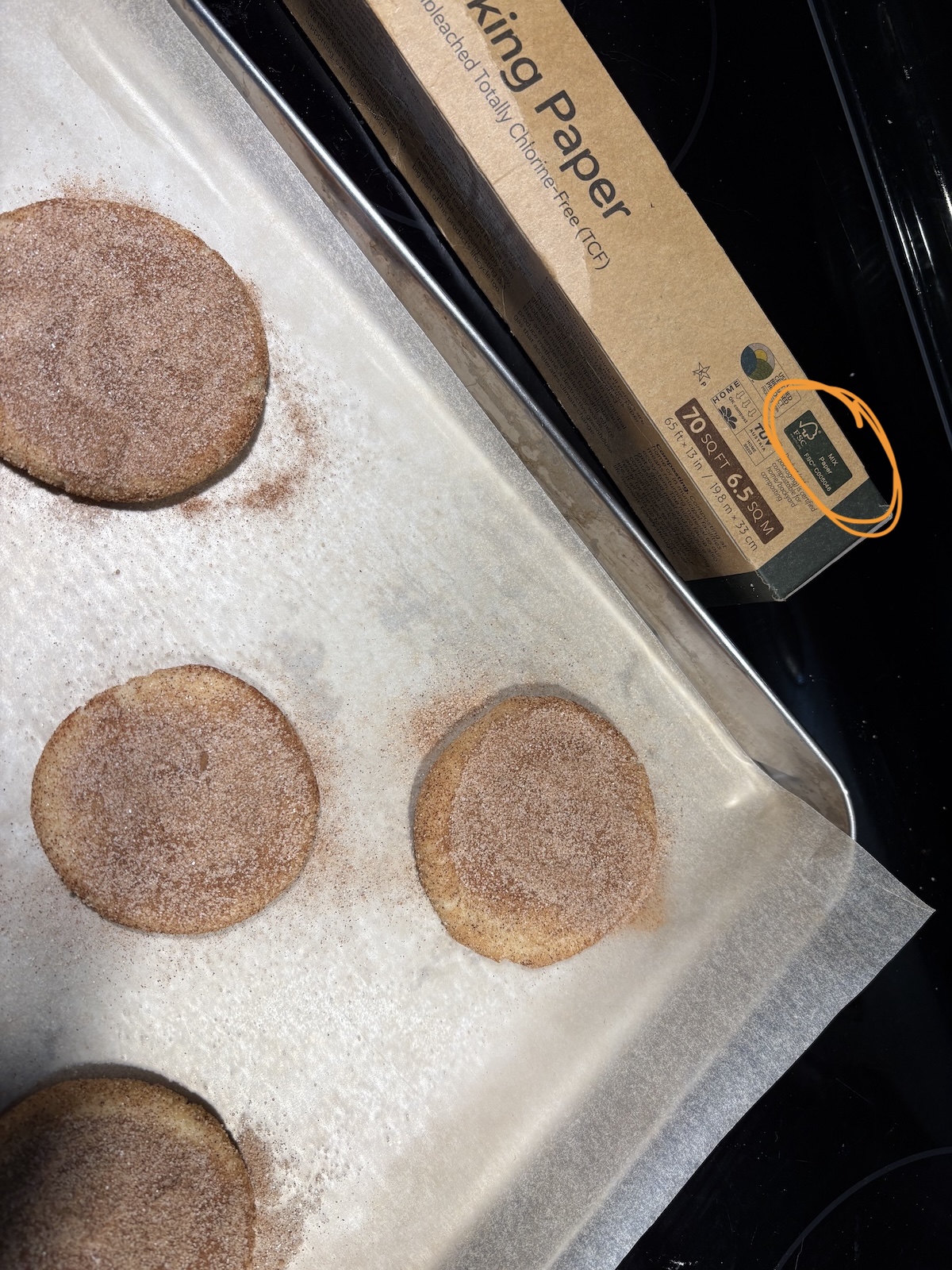 parchment-paper Snickerdoodle cookies freshly backed and sprinkled with cinnamon
