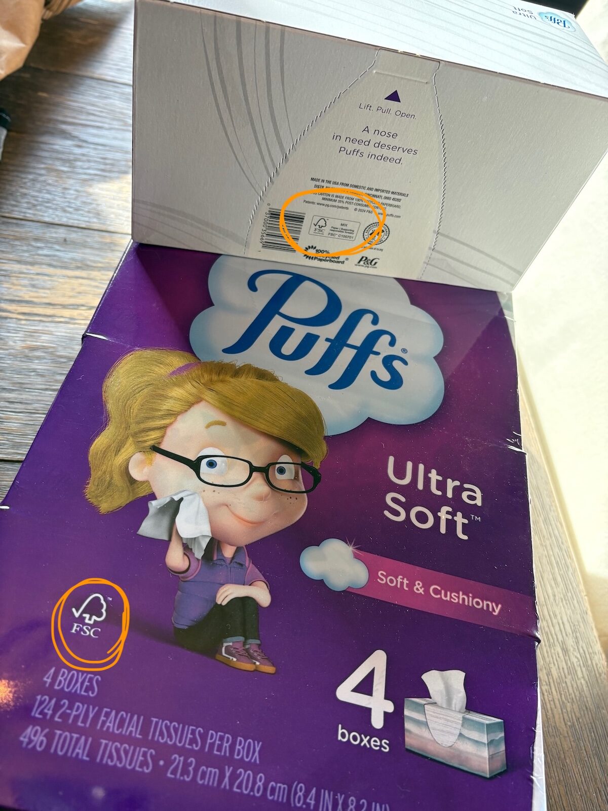 puffs-4 A package of Puffs tissues sit on a wooden table.