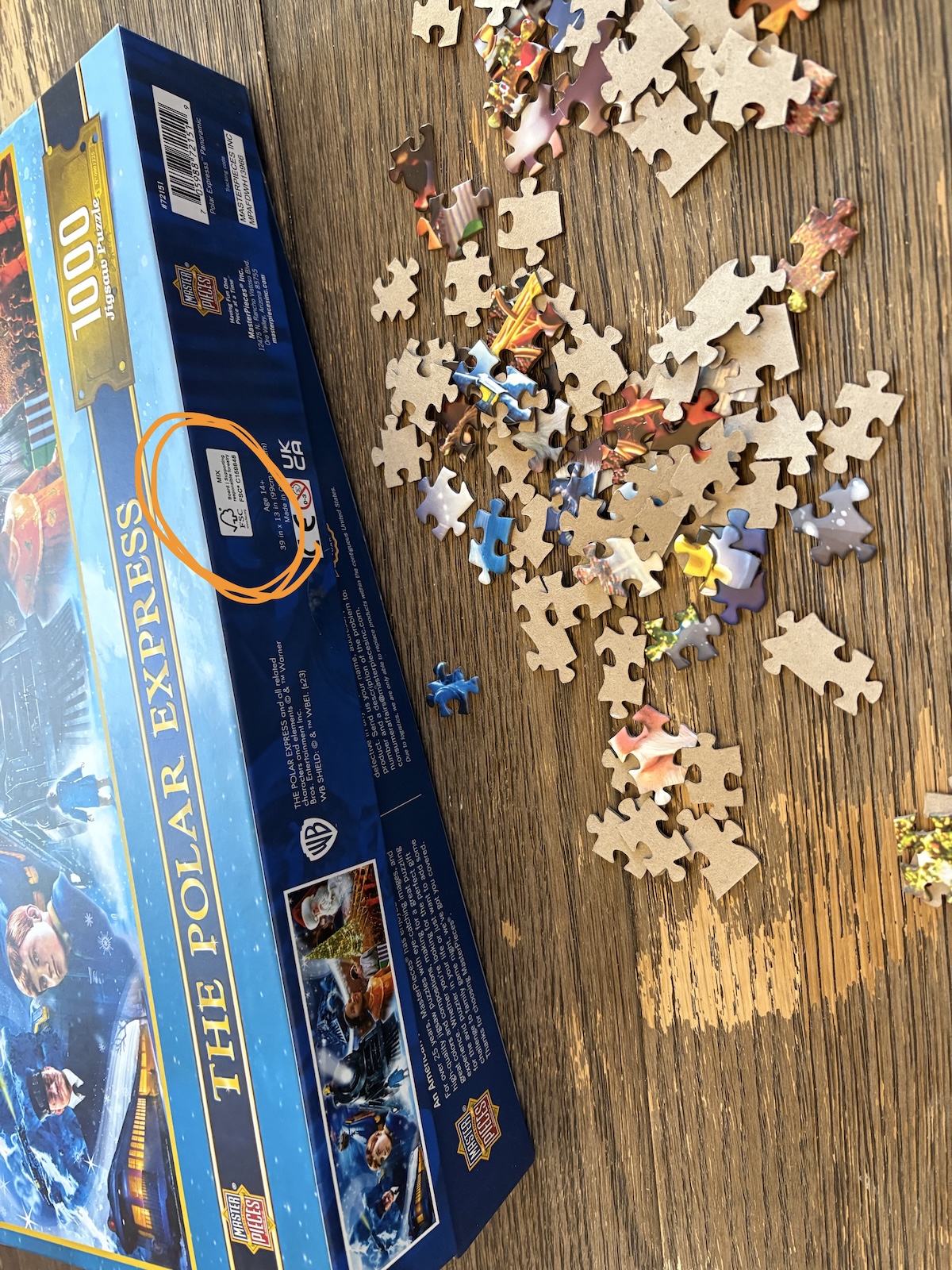 puzzle A puzzle box and puzzle pieces displayed on a wooden table.